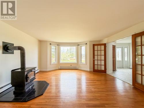 Living room with wood stove - 51-53 Creston Boulevard, Marystown, NL 