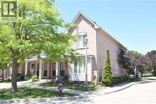 Brick and siding exterior with a pitched roofline - 2 Harbour Drive Unit# 17, Stoney Creek, ON 