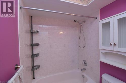 Tub-shower combination featuring white tile surround and chrome fixtures - 2 Harbour Drive Unit# 17, Stoney Creek, ON 