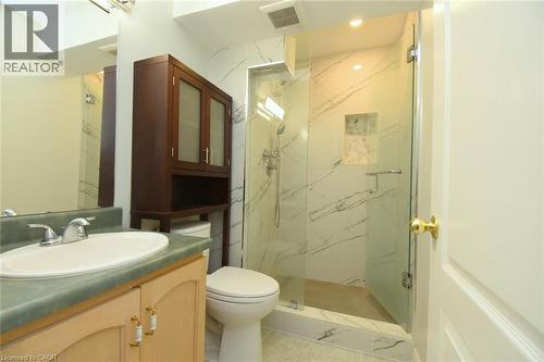 Glass-enclosed shower with a tiled surround featuring a built-in niche - 2 Harbour Drive Unit# 17, Stoney Creek, ON 