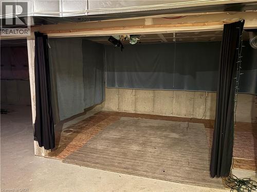 Lower-level space featuring an unfinished concrete floor, exposed joists, and ductwork - 2 Harbour Drive Unit# 17, Stoney Creek, ON 