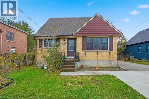 Bungalow with brick siding, a front yard, and roof with shingles - 549 Weber Street E, Kitchener, ON 