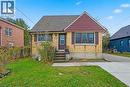 Bungalow with brick siding, a front yard, and roof with shingles - 549 Weber Street E, Kitchener, ON 