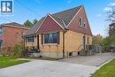 Bungalow featuring brick siding, roof with shingles, and a front lawn - 549 Weber Street E, Kitchener, ON 