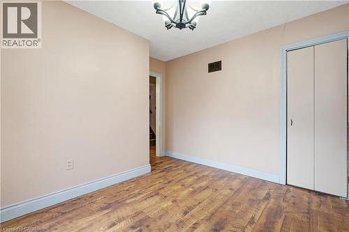 Dining room with wood finished floors, a chandelier, and a closet - 549 Weber Street E, Kitchener, ON 