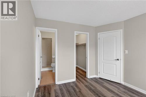 Interior space featuring wood-finish flooring, light neutral wall paint, and white trim - 7 Hepworth Crescent, Ancaster, ON 