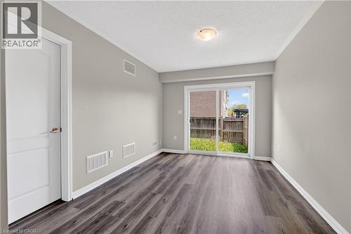 Spacious room featuring wood-finish flooring and neutral wall tones - 7 Hepworth Crescent, Ancaster, ON 