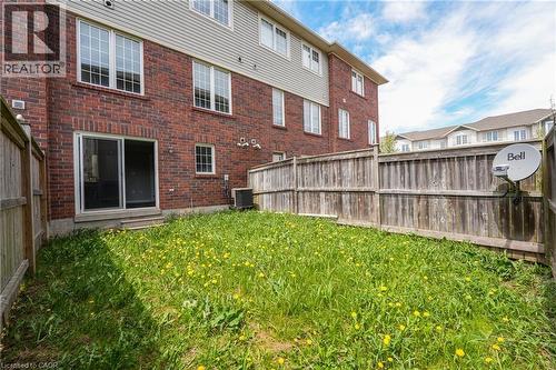 Private backyard with wood fencing and a brick exterior - 7 Hepworth Crescent, Ancaster, ON 