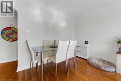 Bright interior space featuring wood-finish flooring, white baseboards, and neutral wall paint - 