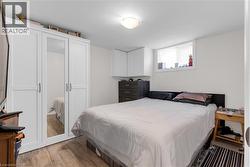 Room featuring white walls and wood-finish flooring - 