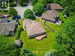 Expansive property featuring a deck, a detached storage shed, and a large grassy yard enclosed by fencing - 