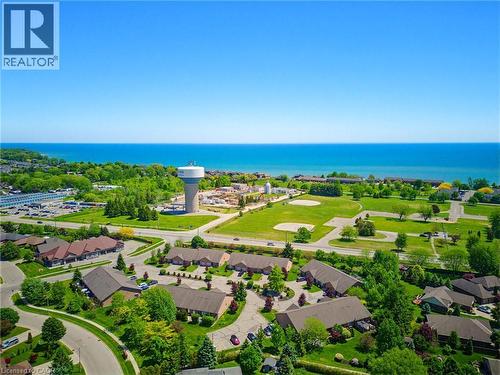 Aerial perspective showcasing extensive water frontage, surrounding green spaces, and community infrastructure - 5 Coastal Court, Port Dover, ON 