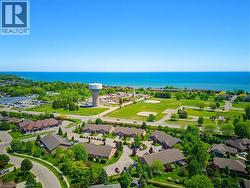 Aerial perspective showcasing extensive water frontage, surrounding green spaces, and community infrastructure - 