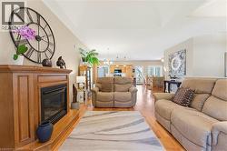 Living room featuring a wood-finish  gas fireplace,  and vaulted ceilings - 