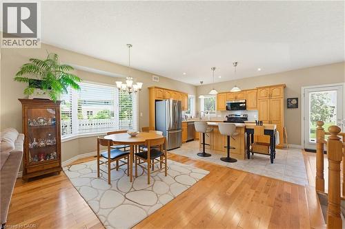 Open-concept kitchen and dining area with hardwood flooring - 5 Coastal Court, Port Dover, ON 