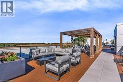 Spacious rooftop deck featuring a wood pergola, composite decking, contemporary planter boxes, and perimeter railing - 