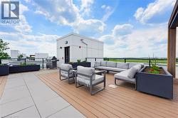 Expansive rooftop terrace featuring wood-finish decking and large format paving - 