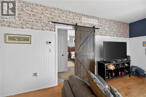 Sliding barn-style door leads to the primary suite. - 6 Gaddye Lane, Binbrook, ON - Indoor