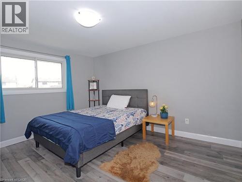 Bright room featuring gray walls, wood-finish flooring, and a large window with white trim - 771 Monsarrat Avenue, London, ON 