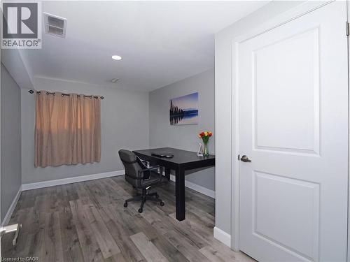Room featuring wood-finish flooring, recessed lighting, and a window with curtain rod - 771 Monsarrat Avenue, London, ON 