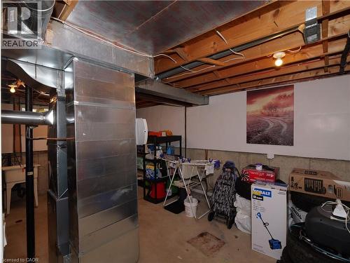 Unfinished basement area featuring exposed wooden ceiling joists, visible ductwork, and concrete flooring - 771 Monsarrat Avenue, London, ON 