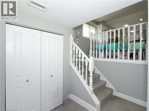 Interior staircase with carpeting and white balusters - 771 Monsarrat Avenue, London, ON 