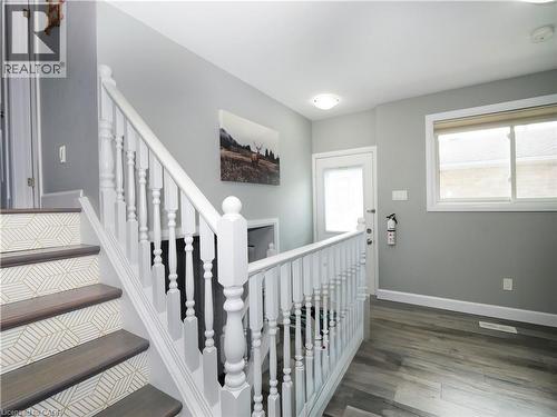 Staircase with patterned risers and white balusters - 771 Monsarrat Avenue, London, ON 