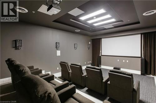 Dedicated media room featuring tiered seating, a large projection screen, built-in projector, integrated wall speakers, and recessed ceiling lighting - 112 King Street E Unit# Ph6, Hamilton, ON - Indoor Photo Showing Other Room