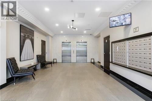 Lobby area featuring two stainless steel elevators, individual mailboxes, and a neutral tile floor - 112 King Street E Unit# Ph6, Hamilton, ON - Indoor Photo Showing Other Room