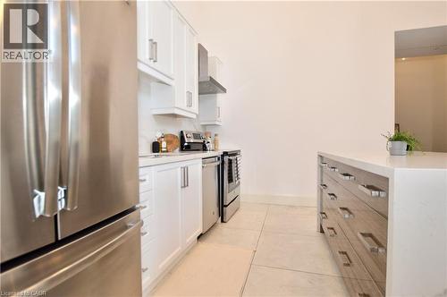 Kitchen featuring white shaker-style cabinetry, stainless steel appliances, a white countertop, and a matching backsplash - 112 King Street E Unit# Ph6, Hamilton, ON - Indoor Photo Showing Kitchen With Stainless Steel Kitchen