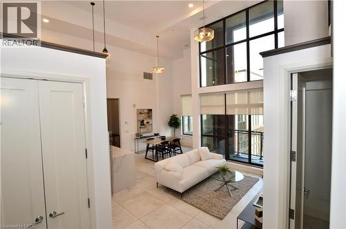 Expansive living area featuring soaring ceilings and oversized windows with roller shades - 112 King Street E Unit# Ph6, Hamilton, ON - Indoor Photo Showing Other Room