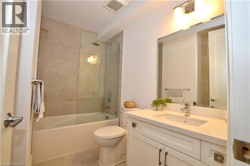 Bathroom featuring a white vanity with an integrated sink, polished chrome faucet, and quartz countertop - 112 King Street E Unit# Ph6, Hamilton, ON - Indoor Photo Showing Bathroom