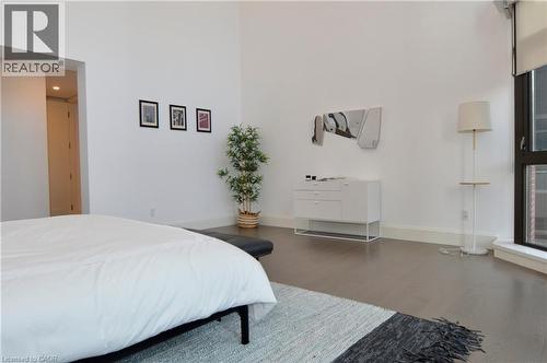 Spacious room featuring high ceilings, dark wood-finish flooring, and large windows - 112 King Street E Unit# Ph6, Hamilton, ON - Indoor Photo Showing Bedroom