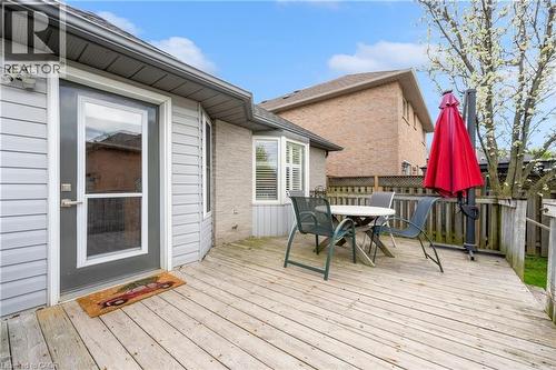 Wood deck with wood railing, featuring gray siding and a full-light exterior door - 50 Spadara Drive, Hamilton, ON 