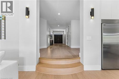 Customized round steps leading from the foyer to the main living area, 11ft ceilings in the kitchen and living room. - 95 Pondcliffe Drive, Kitchener, ON 