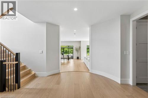 Foyer entryway, curved baseboard details, modern wood and metal stairs - 95 Pondcliffe Drive, Kitchener, ON 