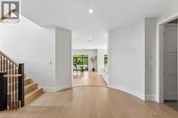 Foyer entryway, curved baseboard details, modern wood and metal stairs - 