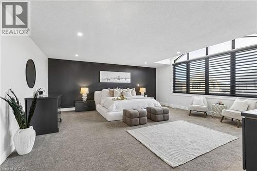 Spacious primary bedroom featuring with premium broadloom,  with clerestory windows, motorized SMART shades by HUNTER DOUGLAS andrecessed lighting - 95 Pondcliffe Drive, Kitchener, ON 