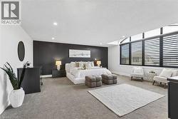 Spacious primary bedroom featuring with premium broadloom,  with clerestory windows, motorized SMART shades by HUNTER DOUGLAS andrecessed lighting - 