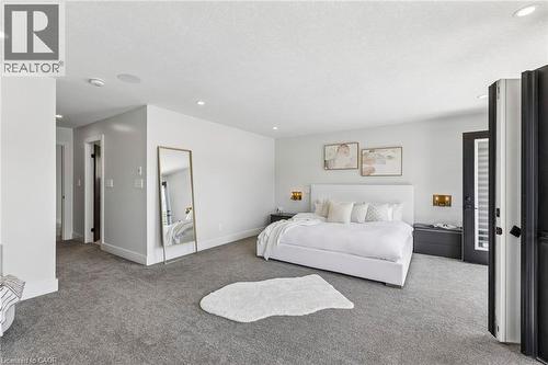 Spacious interior featuring neutral wall tones and dark gray carpeting - 95 Pondcliffe Drive, Kitchener, ON 