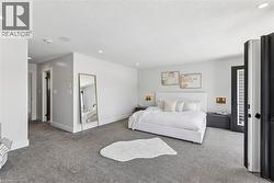 Spacious interior featuring neutral wall tones and dark gray carpeting - 