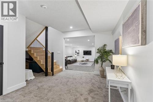 View from the basement landing to the expansive living area, with 9ft ceilings. - 95 Pondcliffe Drive, Kitchener, ON 