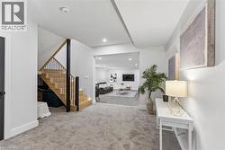 View from the basement landing to the expansive living area, with 9ft ceilings. - 