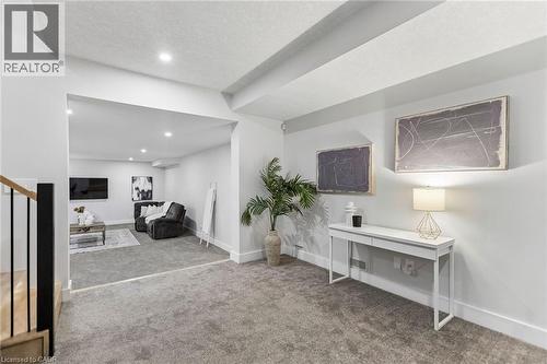 View coming downstairs from the main level, open and airy landing space to the fully-finished basement with 9ft ceiling. - 95 Pondcliffe Drive, Kitchener, ON 