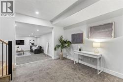 View coming downstairs from the main level, open and airy landing space to the fully-finished basement with 9ft ceiling. - 
