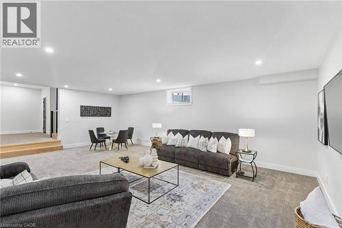 Spacious and inviting basement recreation room featuring lots of recessed lighting, light gray premium carpeting, and .9ft ceilings - 95 Pondcliffe Drive, Kitchener, ON 