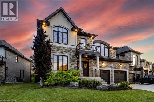 Stone and stucco facade featuring arched and rectangular windows - 95 Pondcliffe Drive, Kitchener, ON 