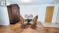 Wood-finish flooring throughout the main living area, complemented by a light-toned entryway floor - 