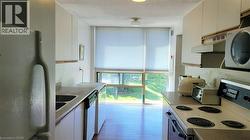 Kitchen featuring white cabinetry, a double basin sink, and a built-in dishwasher - 