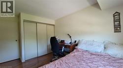Wood-finish flooring with a white interior door and sliding closet doors - 